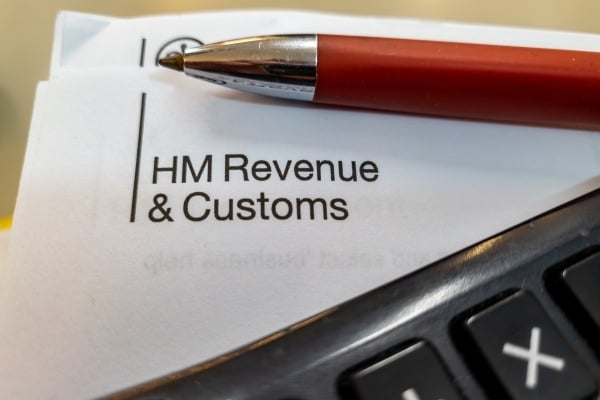 Official paperwork from HM Reveue & Customs with a pen and calculator